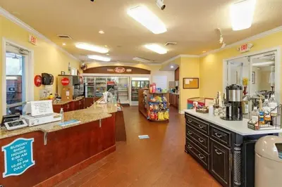 a grocery store with a counter in the middle of a room at 2025 Deals Are Here! Book Now Before Rates Go Up! in Kissimmee