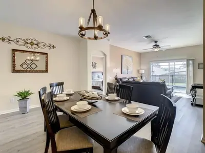 a dining room and living room with a table and chairs at 2025 Deals Are Here! Book Now Before Rates Go Up! in Kissimmee