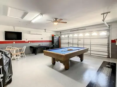 a room with a ping pong table in a garage at 2025 Deals Are Here! Book Now Before Rates Go Up! in Kissimmee