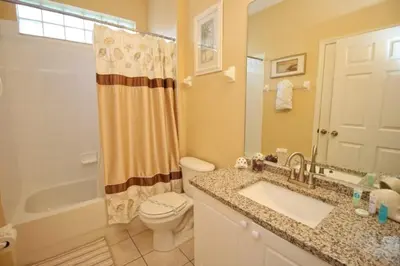 a bathroom with a sink and a toilet and a shower at Luxury Villa With Private Pool And Great Game Room villa in Kissimmee