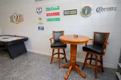 a room with a ping pong table and two chairs at Luxury Villa With Private Pool And Great Game Room villa in Kissimmee