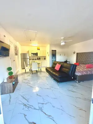 a living room with a couch and a table at Happy Place in Orlando