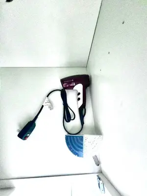 a shelf with a hair dryer in a wall at Happy Place in Orlando