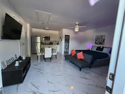 a living room with a bed and a couch and a table at Happy Place in Orlando