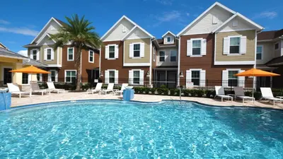 a large swimming pool in front of some houses at 5 BR 6 BA Villa 5min to Disney! SMV154 in Orlando