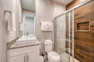 a bathroom with a toilet and a sink and a shower at 5 BR 6 BA Villa 5min to Disney! SMV154 in Orlando