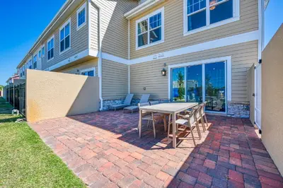 a patio with a table and chairs in front of a house at 5 BR 6 BA Villa 5min to Disney! SMV154 in Orlando