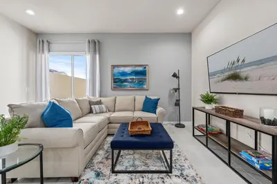 a living room with a couch and a table at Comfortable home w 3 En-suites! SMV157 in Orlando