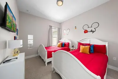 two beds in a bedroom with red sheets at 4 Bedrooms 3 En-Suites, 5 Min to Disney SMV158 in Orlando