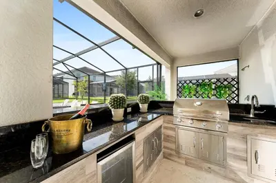 a kitchen with a stove and some windows at UNIQUE MASTERPIECE15 Suites Sleeps 30 SON101 in Kissimmee
