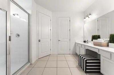 a white bathroom with a shower and a sink at UNIQUE MASTERPIECE15 Suites Sleeps 30 SON101 in Kissimmee
