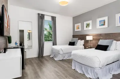a hotel room with two beds and a window at UNIQUE MASTERPIECE15 Suites Sleeps 30 SON101 in Kissimmee