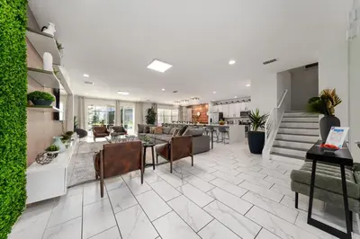 a living room with a couch and a table and chairs at UNIQUE MASTERPIECE15 Suites Sleeps 30 SON101 in Kissimmee