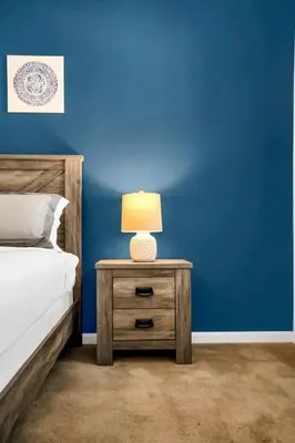 a nightstand with a lamp on it next to a bed at Luxury Home at Sonoma 9 En-suites SON102 in Kissimmee