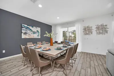 a dining room with a table and chairs at Luxury Villa w Pool, Home Cinema, BBQ & Near Disney Parks in Kissimmee