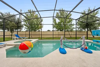 a pool with a beach ball and a volleyball at Luxury Villa w Pool, Home Cinema, BBQ & Near Disney Parks in Kissimmee