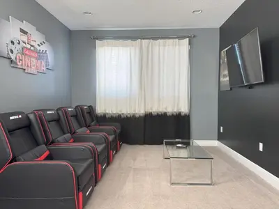 a waiting room with black leather chairs and a glass table at 7491 Oasis at Reunion sleeps 12 in Orlando