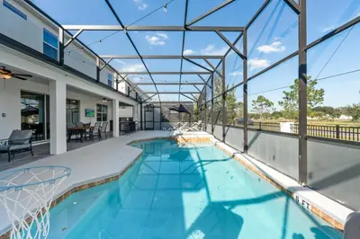 an indoor swimming pool with a glass roof at Unique Masterpiece 15 En-suites VPR104 in Kissimmee