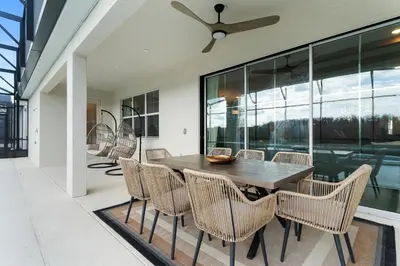 a dining room with a table and chairs at Brand New Masterpiece 15 En-Suites SON105 in Kissimmee