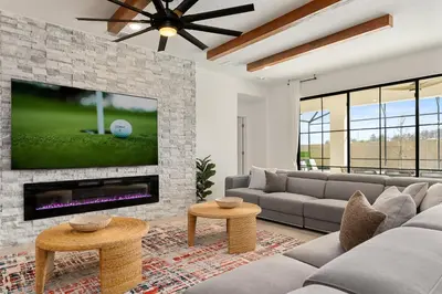 a living room with a couch and a fireplace at Brand New Masterpiece 15 En-Suites SON105 in Kissimmee
