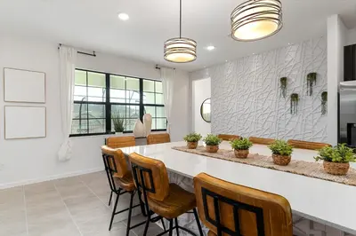 a kitchen with a large table and chairs at Brand New Masterpiece 15 En-Suites SON105 in Kissimmee