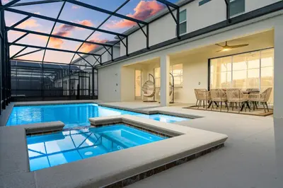 a swimming pool in a house with a glass ceiling at Brand New Masterpiece 15 En-Suites SON105 in Kissimmee