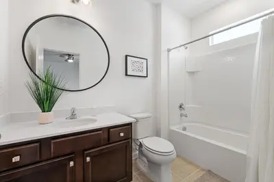a bathroom with a sink and a toilet and a mirror at Brand New Masterpiece 15 En-Suites SON105 in Kissimmee