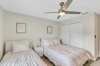 a bedroom with two beds and a ceiling fan at Private Pool 8 Min to Disney STL121 in Kissimmee