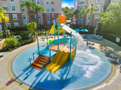 a water park with a slide and a water fall at Epic Universe Premium Lake View Condo, Vista Cay - 1002 in Orlando