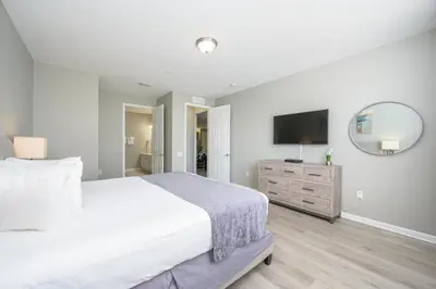 a bedroom with a large bed and a flat screen tv at Beautiful Lake View Condo, Vista Cay-1004 in Orlando