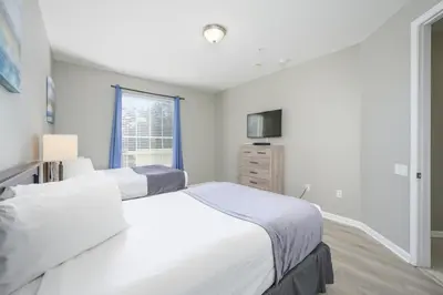 a bedroom with two beds and a window at Beautiful Lake View Condo, Vista Cay-1004 in Orlando