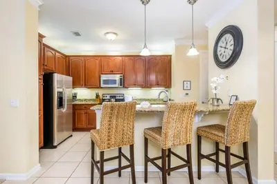 a kitchen with a large island with bar stools at Gorgeous 3 Bed Lakeview, Vista Cay - 1010 in Orlando