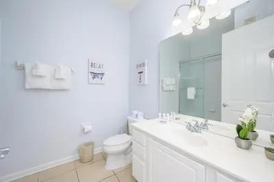 a white bathroom with a sink and a toilet at Beautiful Lakeview Vacation Condo, Vista Cay 1016 in Orlando