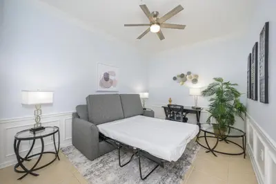 a living room with a couch and two tables at Beautiful Lakeview Vacation Condo, Vista Cay 1016 in Orlando