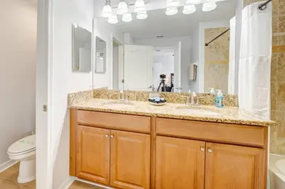 a bathroom with a sink and a mirror at This Happy Place in Kissimmee