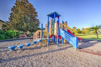 a playground with a slide in a park at This Happy Place in Kissimmee