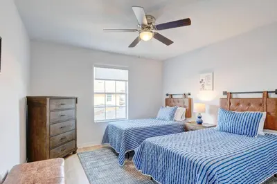 a bedroom with two beds and a ceiling fan at This Happy Place in Kissimmee