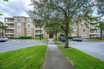 a parking lot in front of a large building at Epic Universe New Listing! Lakeview Condo, Vista Cay - 1017 in Orlando