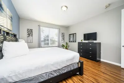 a bedroom with a large bed and a television at Epic Universe Family Fun Vista Cay Lakeview Condo - 1021 in Orlando