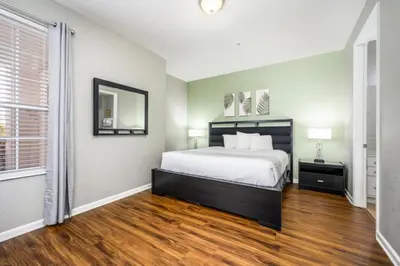 a bedroom with a bed and a large window at Epic Universe Family Fun Vista Cay Lakeview Condo - 1021 in Orlando