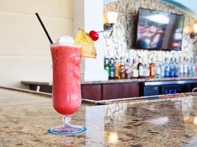 a drink in a glass sitting on top of a bar at Beautiful Lakeview Condo, New Listing -1024 in Orlando