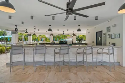 a bar with stools in the middle of a room at Beautiful Lakeview Condo, New Listing -1024 in Orlando