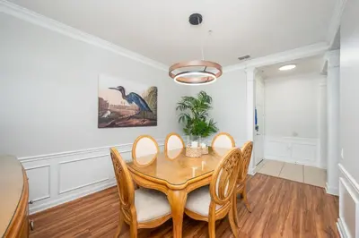 a dining room with a wooden table and chairs at Beautiful Lakeview Condo, New Listing -1024 in Orlando