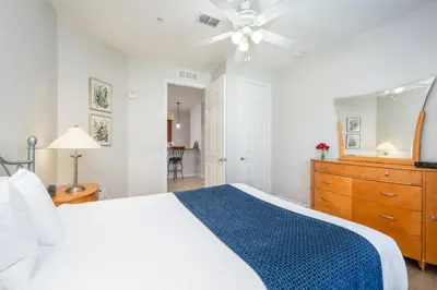 a bedroom with a white bed and a ceiling fan at Beautiful Lakeview Condo, New Listing -1024 in Orlando