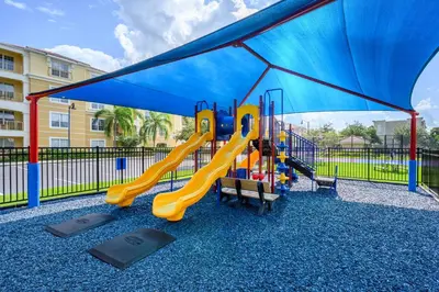 a playground with a slide and a blue canopy at Epic Universe New Beautiful Lakeview Condo Near The Parks - 1026 in Orlando