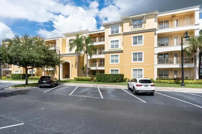 a parking lot in front of a large building at Stunning Vacation Condo - Vista Cay Resort - 2008 in Orlando