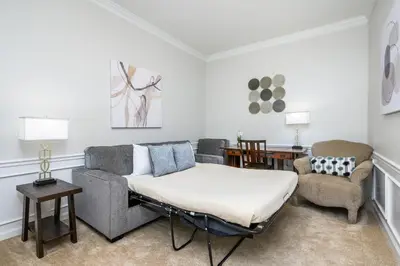 a living room with a couch and a bed at Penthouse Vacation Condo, Near The Parks - 2015 in Orlando