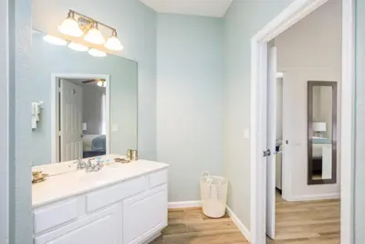 a bathroom with a white sink and a mirror at Beautiful Deluxe Condo, Vista Cay, Orlando - 3008 in Orlando