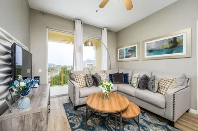 a living room with a couch and a table at Beautiful Deluxe Condo, Vista Cay, Orlando - 3008 in Orlando