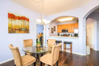 a dining room with a glass table and chairs at Vista Cay Deluxe Condo, Vista Cay - 3010 in Orlando
